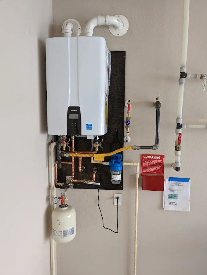 Professional plumber installing copper piping in a Edgemere home